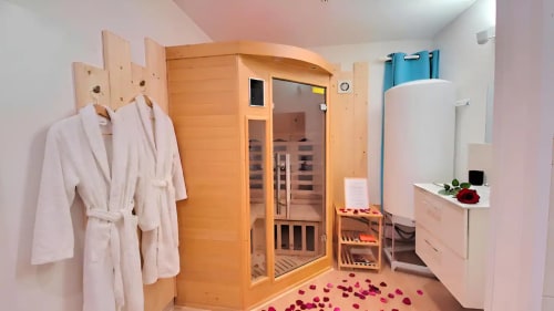 Suite spa Residence Kelys B&B à Boulogne-Sur-Mer avec sauna en bois, peignoirs blancs et pétales de rose