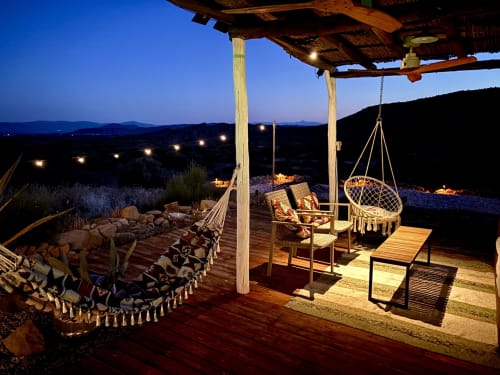 Terraço El Sueño ao anoitecer com cadeira suspensa, fogueira e vistas para as montanhas em Huércal-Overa