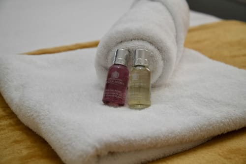 Two Molton Brown miniature toiletries on white towel at Love Short Stays hotel, South Shields