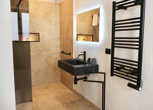 Bagno moderno in Tagasuites Catania Suite Deluxe con lavabo nero, scaldasalviette e doccia con piastrelle beige