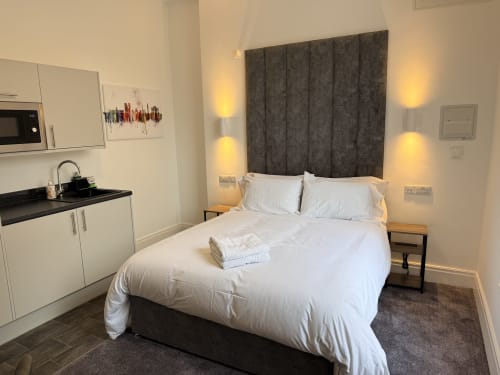 Modern studio apartment at Fishergate Residences Preston with king sized bed, kitchenette, and contemporary decor