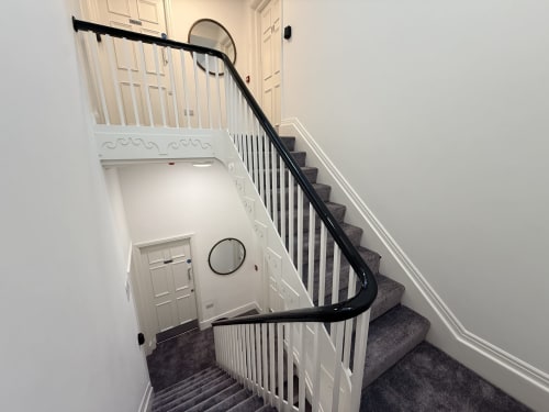 Staircase with black handrail at Fishergate Residences hotel in Preston