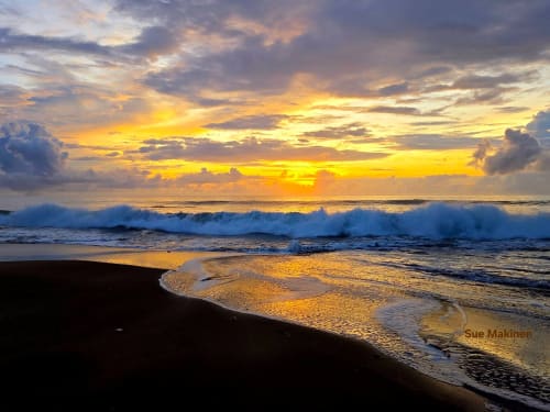 Golden sunset with rolling waves on black sand beach at El Litoral Wellness Retreat, PA
