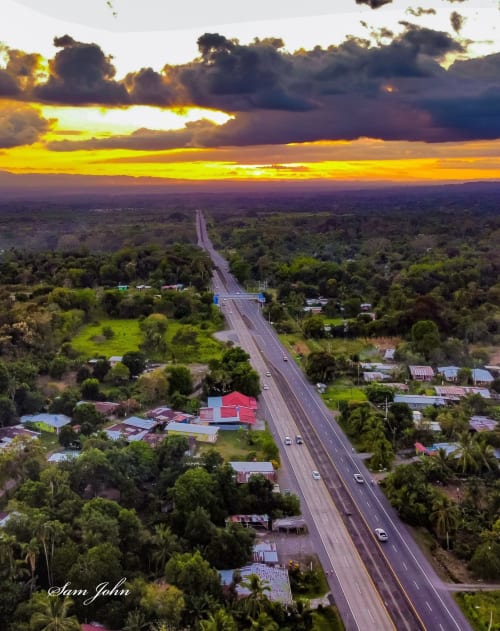 Aerial sunset view of highway through lush forest near El Litoral Wellness Retreat in PA