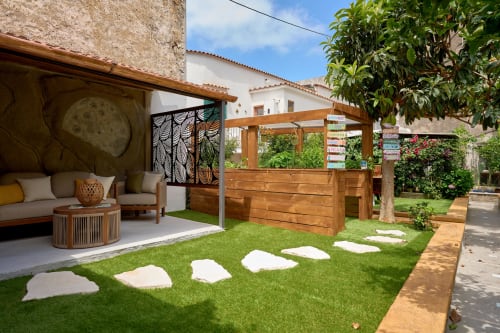Garden lounge area at Sorrento Sea View villa with wooden pergola, seating, and stepping stones on lawn