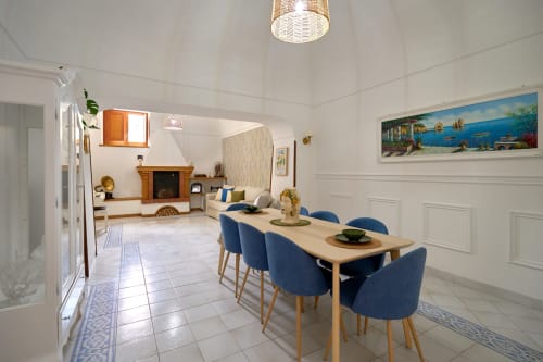 Bright dining room in The Lemon Garden Escape villa at Sorrento Sea View with blue chairs, wooden table, and Mediterranean