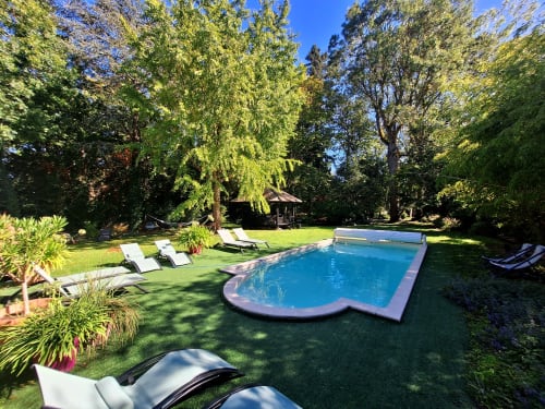 Les Rives De La Tronne resort pool surrounded by lounge chairs and lush gardens in Mer, France