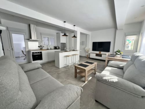 Lujoso apartamento de playa diáfano en Fuengirola con cocina moderna, sala de estar y asientos grises