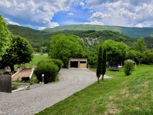 Gîte de la Méouge avec vue montagne, allée gravillonnée, pelouses verdoyantes et paysage de vallée luxuriant à Barret-sur-Méouge