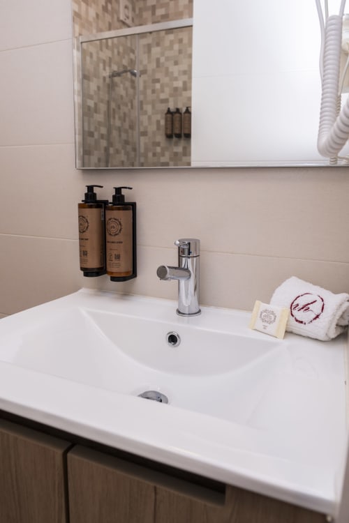 Modern bathroom sink with amenities at RH Charming Apartments in Braga