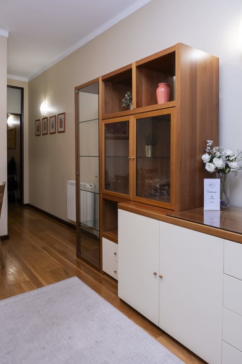 Modern hallway entrance with wooden storage cabinet and white drawers at RH Charming Apartments, Braga
