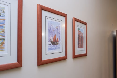 Framed artwork displaying Asian junk boat and historic architecture in RH Charming Apartments, Braga