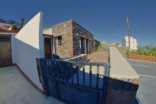 Casa La Tabona cottage exterior with blue gate and stone walls, La Frontera, Canary Islands, Spain