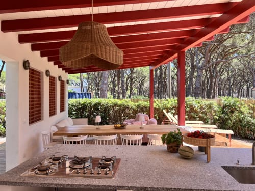 Casa Rossa villa at Casa Pineta with red pergola, dining area, kitchen, and sea view in Marina di Campo