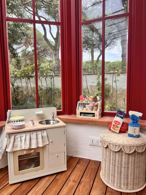 Playroom with toy kitchen overlooking sea view at Casa Pineta villa, Marina di Campo