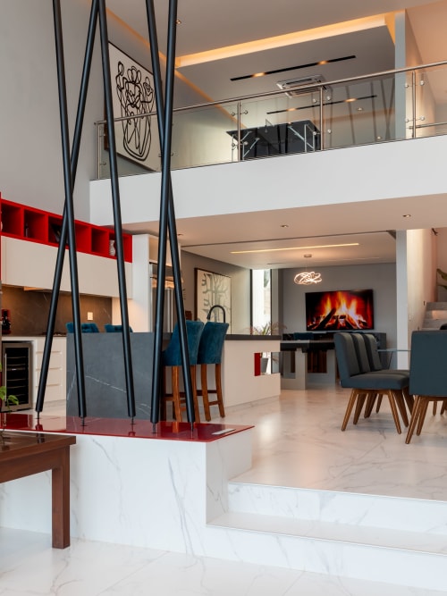 Modern Villa E11even interior at Isla Mujeres Realty with open-plan living, fireplace, and sea views