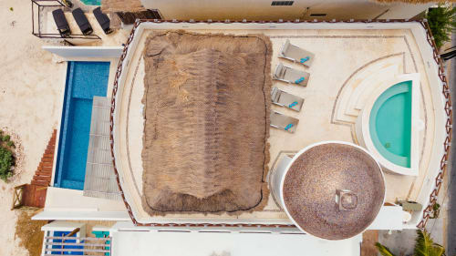 Aerial view of Casa Javi beachfront cottage in Isla Mujeres with pools, lounge chairs, and sandy patio