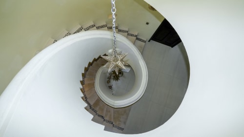 Spiral staircase with decorative star ornament at Casa Javi Ocean Front cottage in Isla Mujeres, Mexico