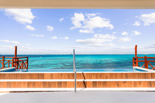 Turquoise Caribbean sea view from Villa Azul Maya balcony in Isla Mujeres with wooden railings