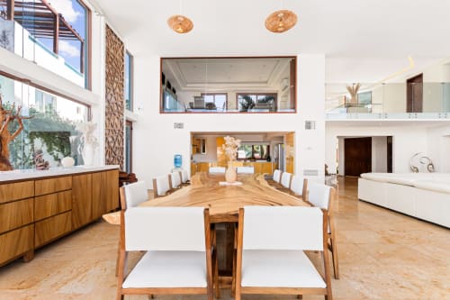 Modern open-plan dining and living area in Villa Azul Maya, Isla Mujeres with wooden table, sea views, and contemporary decor