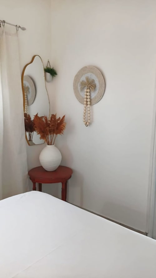 Coastal cottage decor at Le Nid De Bellemont with mirror, dried flowers, and wall decorations