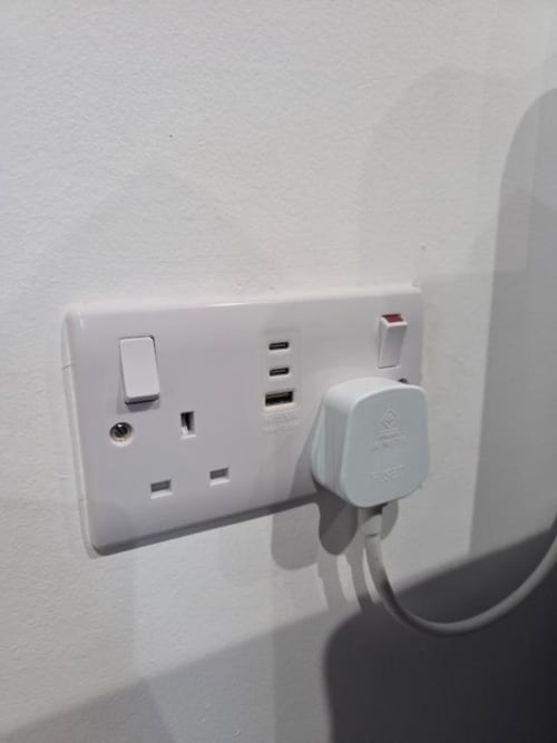 White wall socket with USB ports and power outlets at The Courtyard by JS Apartments in Blackburn