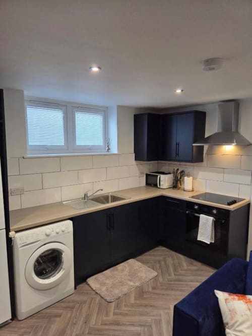 Modern black and white kitchen with subway tile backsplash at The Courtyard by JS Apartments, Blackburn