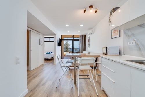 Modern kitchen-dining area with sea views at Cactus Dunes Seaview apartment, Gran Canaria