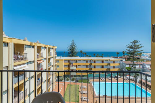 Balcony view of Cactus Dunes Seaview apartment with pool, garden and Mediterranean Sea, San Bartolomé de Tirajana