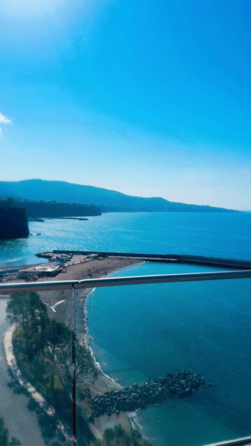 Turquoise coastline with cliffs and beach at Sorrento Sea View, Meta, Italy