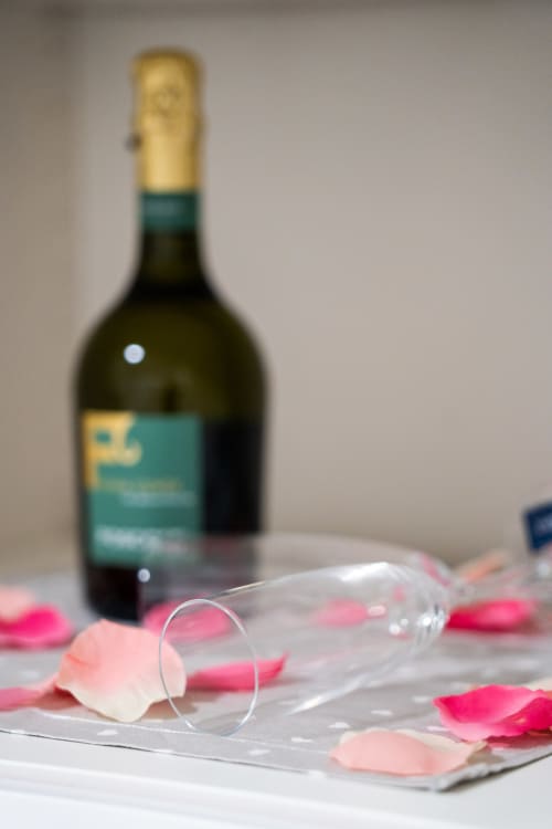 Champagne bottle with rose petals on table at Sorrento Sea View hotel in Meta, Italy