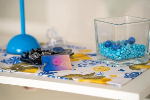 Beach-themed party setup with blue decorations, seashells, and glass container at Sorrento Sea View hotel