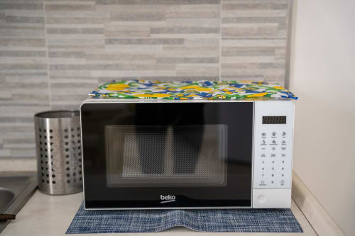 Beko microwave with colorful cover on kitchen counter at Sorrento Sea View hotel apartment