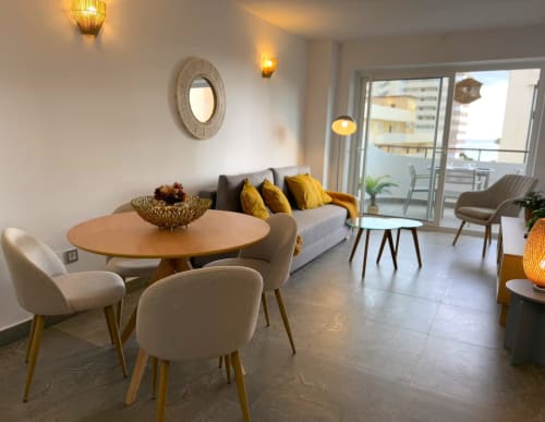 Moderno apartamento soleado en Fuengirola con comedor contemporáneo, detalles en amarillo y vistas a la ciudad