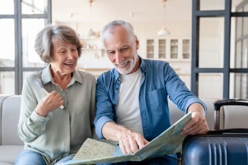 Happy senior couple reviewing travel map at El Litoral Wellness Retreat bed and breakfast in Pennsylvania