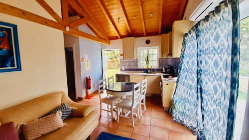 Mountain View Chalet kitchen and dining area at Quinta Boa Vida in Alcobaça with wooden beams, dining table, and garden views