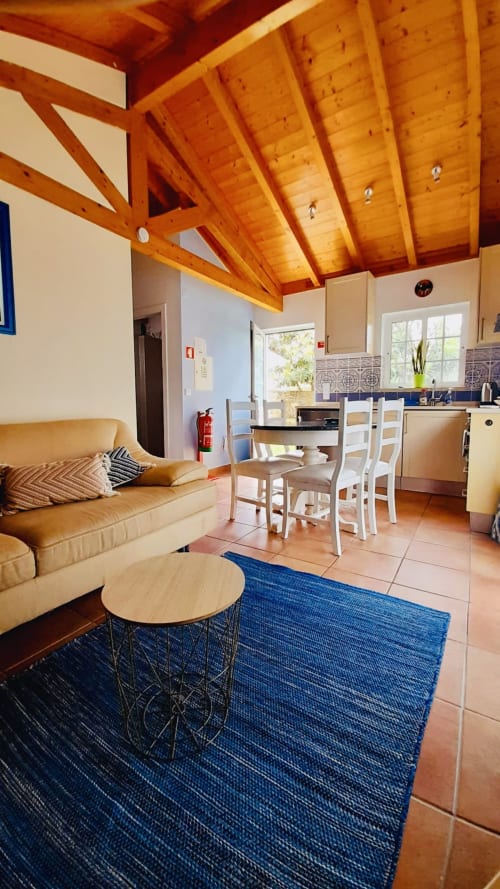 Mountain View Chalet living and kitchen area at Quinta Boa Vida with wooden beams, terrace access, and modern amenities in