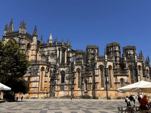 Alcobaça Monastery's Gothic architecture with stone towers and courtyard, Portugal