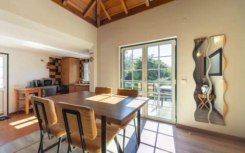 Orchard View Villa dining area at Quinta Boa Vida, Alcobaça with garden views through glass doors and modern décor