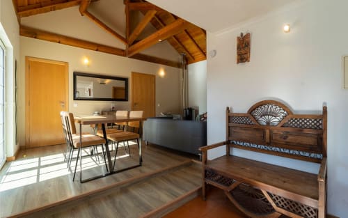 Orchard View Villa at Quinta Boa Vida, Alcobaça - spacious room with exposed beams, wooden bed, dining area and garden views