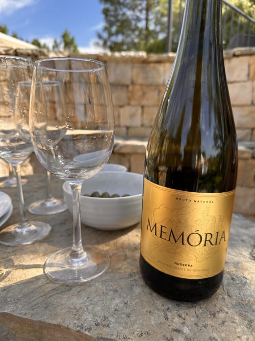 Memoria Bruto Natural wine bottle and glasses on outdoor terrace at Quinta Boa Vida, Alcobaça