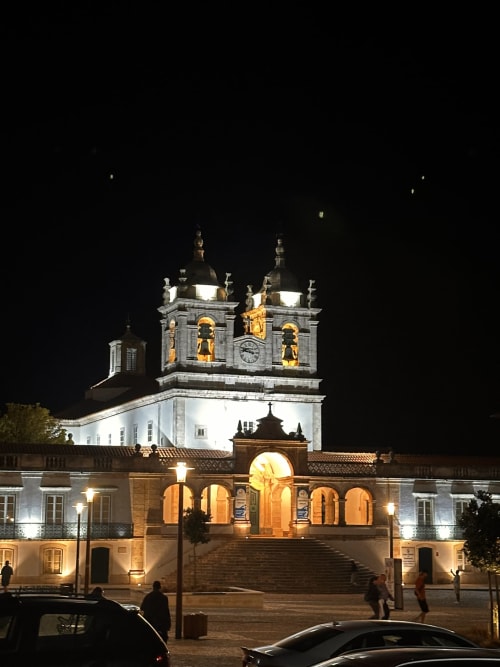 Illuminated historic church with twin towers in Alcobaça, Portugal at night, near Quinta Boa Vida accommodation