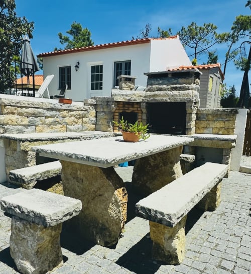 Stone picnic table in garden courtyard of Quinta Boa Vida romantic chalet villa, Alcobaça Portugal