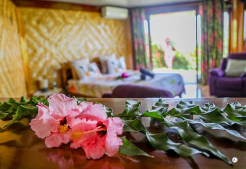 Fleurs roses sur table, chambre de villa moderne avec vue sur la mer à Aimehome, Teavaro