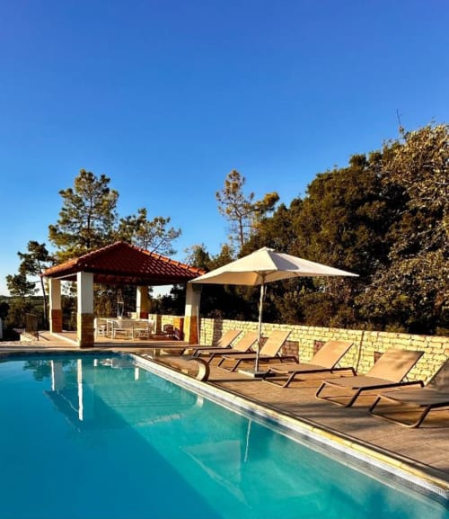 Quinta Boa Vida pool with loungers, umbrella, and red-roofed gazebo overlooking trees in Alcobaça