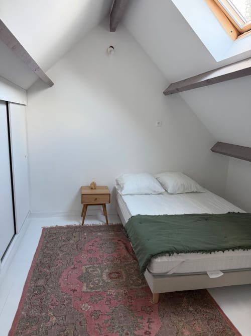 Chambre mansardée chaleureuse au Le 426 B&B de Mouvaux avec puits de lumière, poutres bois et tapis vintage