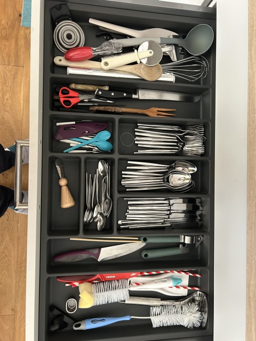 Organized kitchen drawer with utensils, cutlery, and cooking tools at Dream Properties in La Plagne Tarentaise