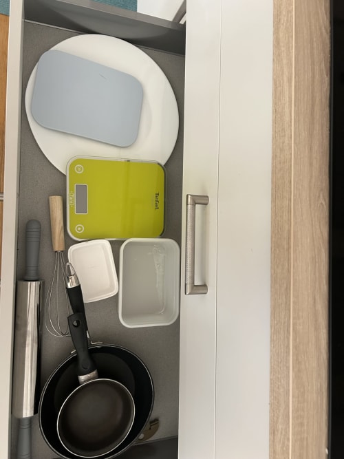 Dream Properties kitchen drawer with yellow Tefal scale, cookware, and utensils in La Plagne Tarentaise