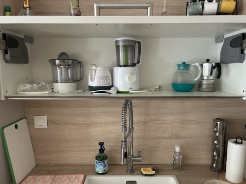 Well-organized kitchen shelf with appliances at Dream Properties, La Plagne Tarentaise