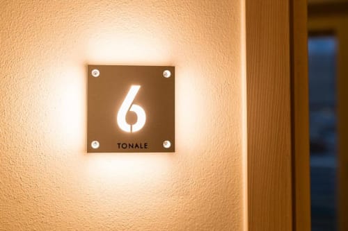 Insegna illuminata con numero 6 della Stanza Tonale presso Le Alpi bed & living a Cividale Camuno, Italia